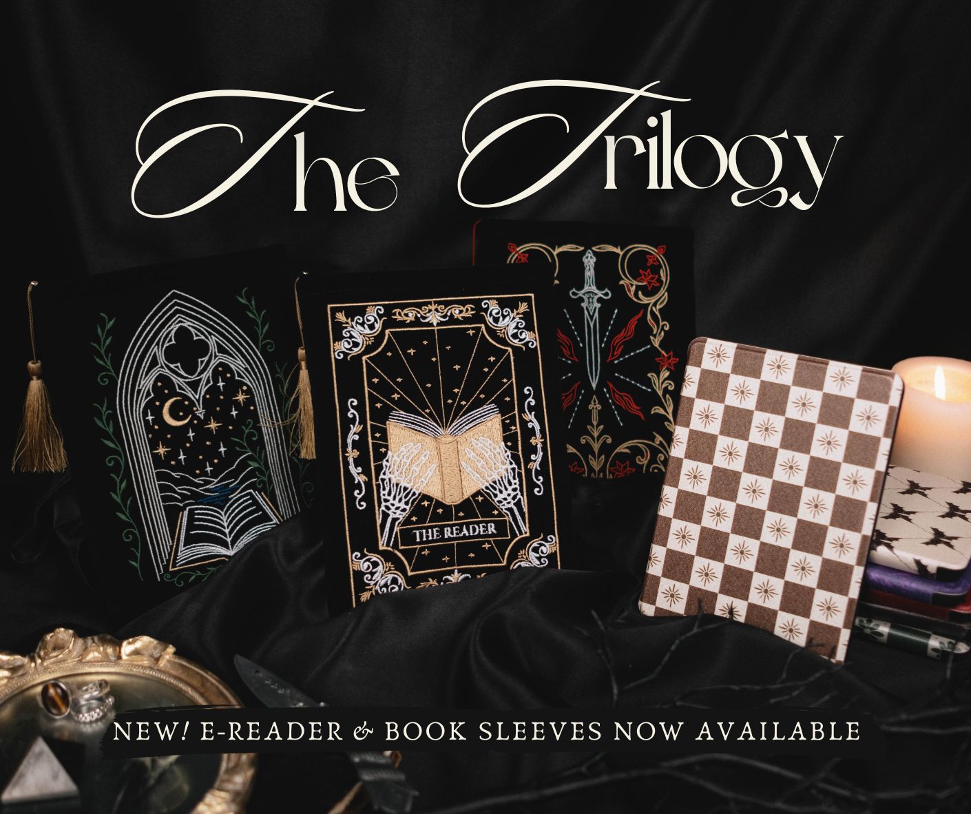 E-reader and book sleeves with decorative designs on a dark background, featuring fantasy elements.