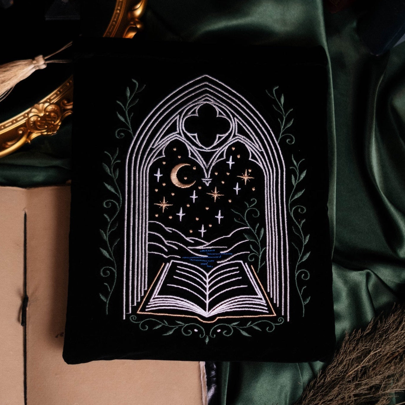 Decorative book with gothic design on a green fabric background