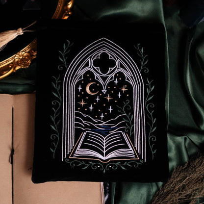 Decorative book with gothic design on a green fabric background