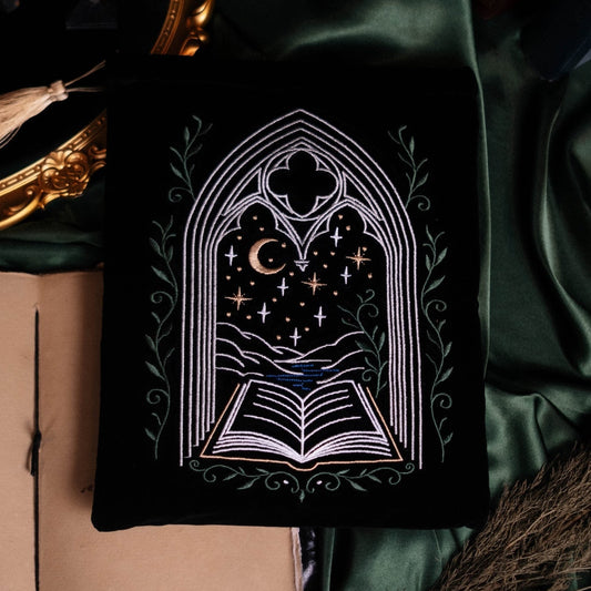 Decorative book with gothic design on a green fabric background