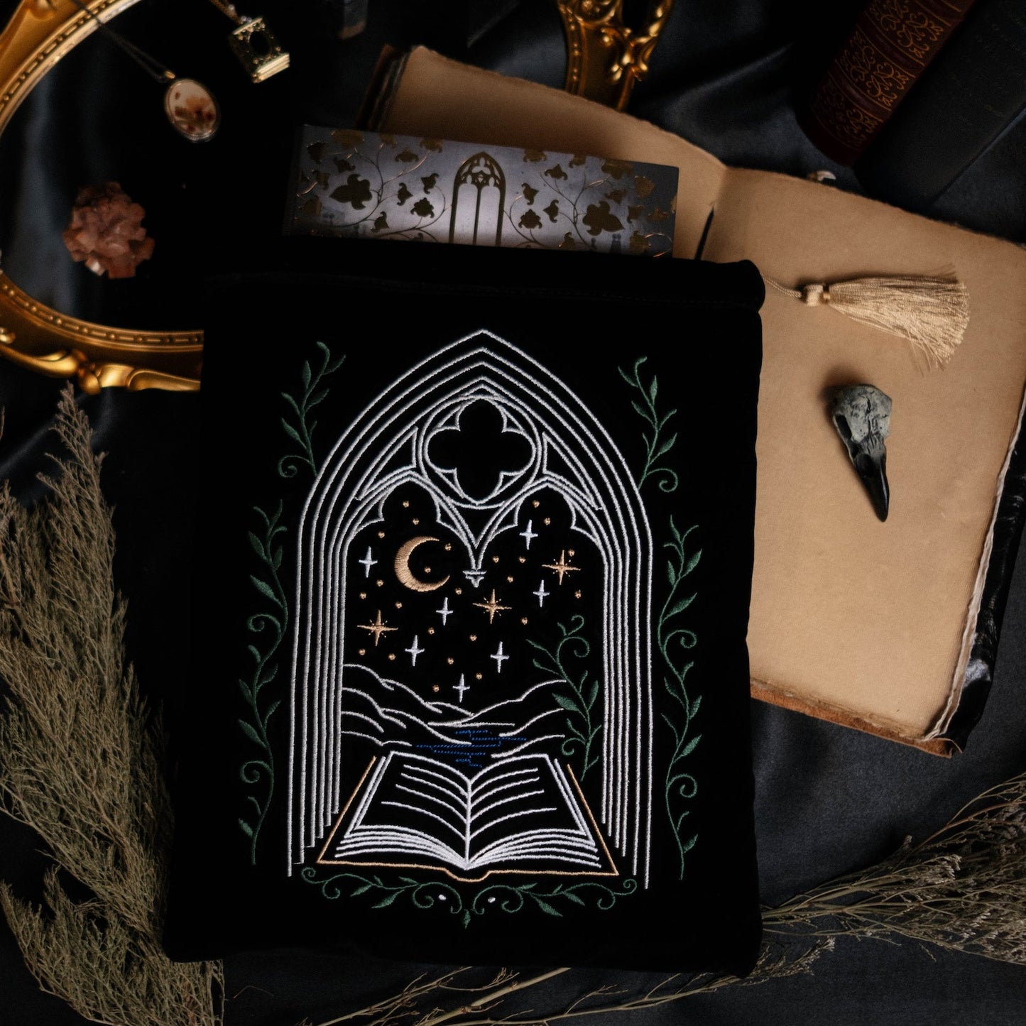 Decorative book sleeve with a gothic design on a dark fabric background